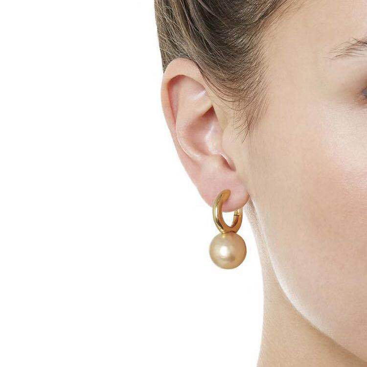 Contemporary Pearl Dangle Hoop Earrings on model single ear